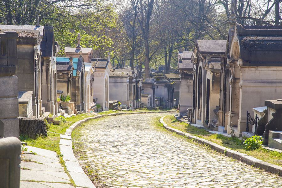 This is an image of a cemetery with headstones lining the path.