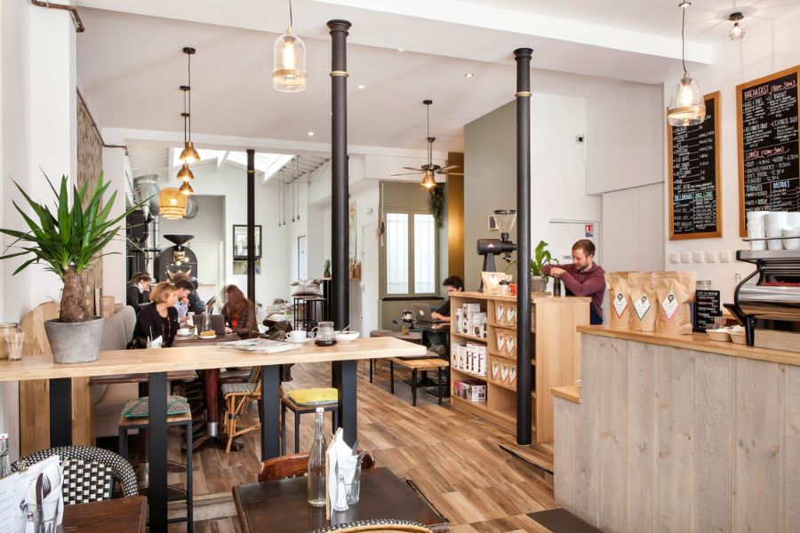 This is an image of the interior of a minimalist café with lovely seating.