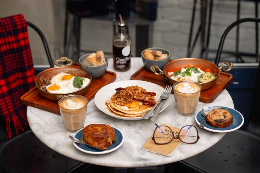 This is an image of a big breakfast spread laid out on a café table.