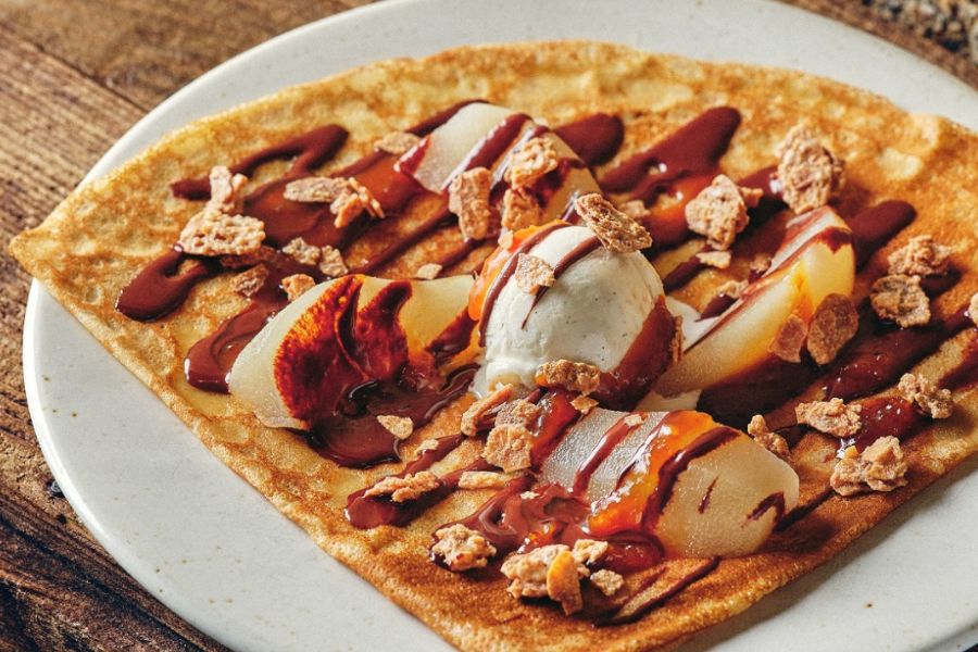 This is an image of a delicious crepe with toppings.