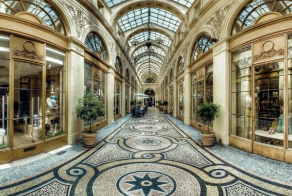 This is an image of Galerie Vivienne, which is a passageway with plenty of shops and lovely tiled floors. It looks very regal.