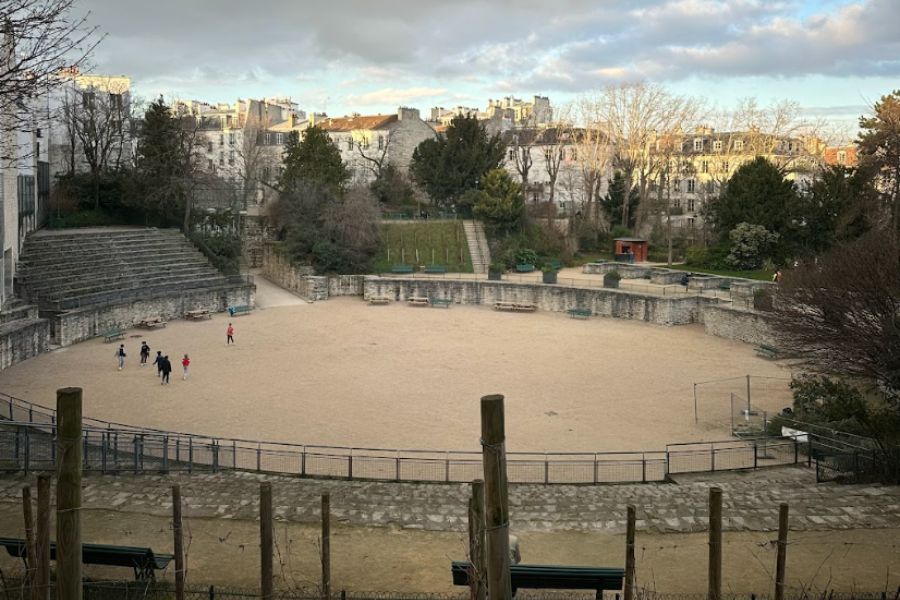 This is an image of a large Roman-esque square with greenery and trees surrounding.