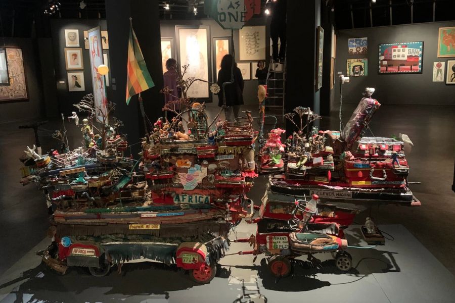 This is an image of an art gallery full of contemporary art pieces and structures. They are very colourful and laid out all over the room.