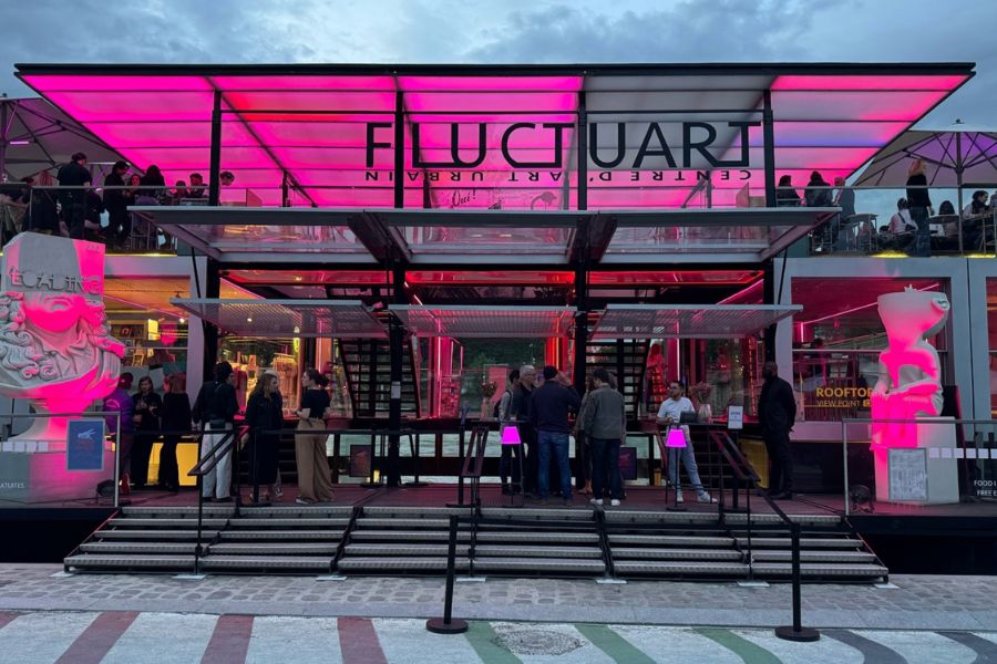 This is an image of a big museum with neon pink lights out front, fitted with a rooftop.