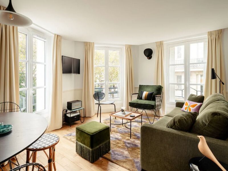 This is a lovely apart-hotel in the heart of Paris with a living room area, dining, kitchen and bedroom.
