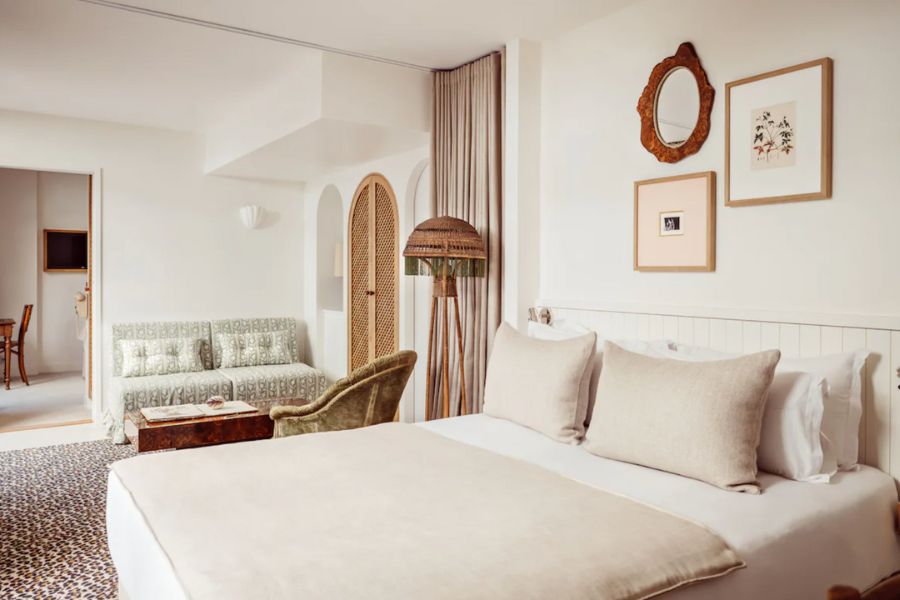 This is an image of a white, minimalist hotel room in Paris.
