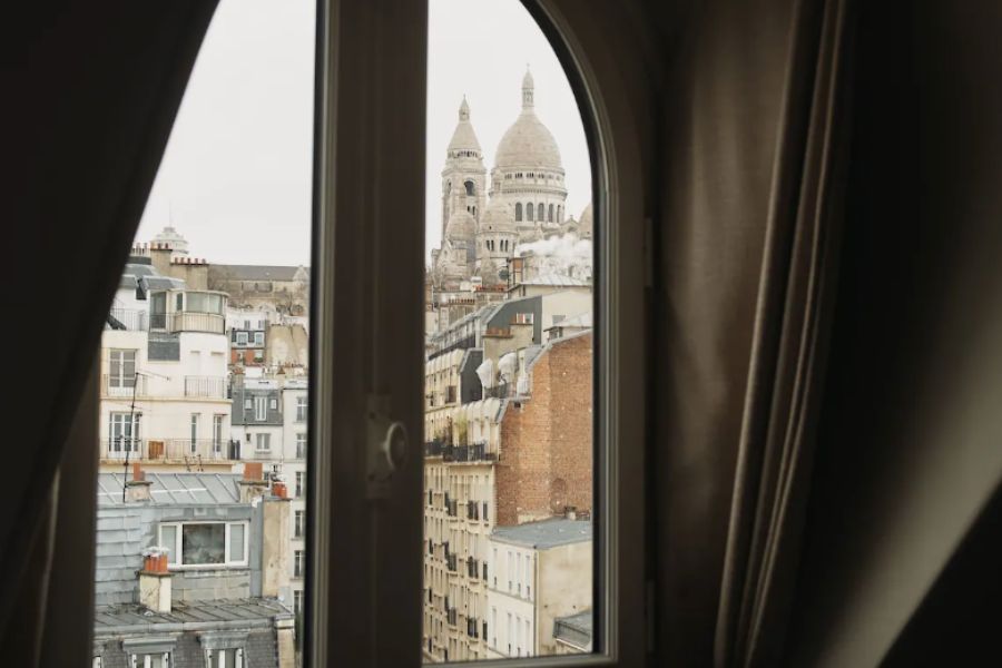 This is an image of the Sacre Coeur Cathedral outside the window of a hotel.