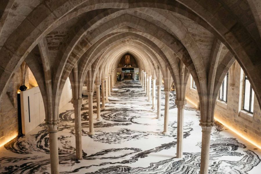 This is an image of the inside of a beautiful building with arched marble balustrades.