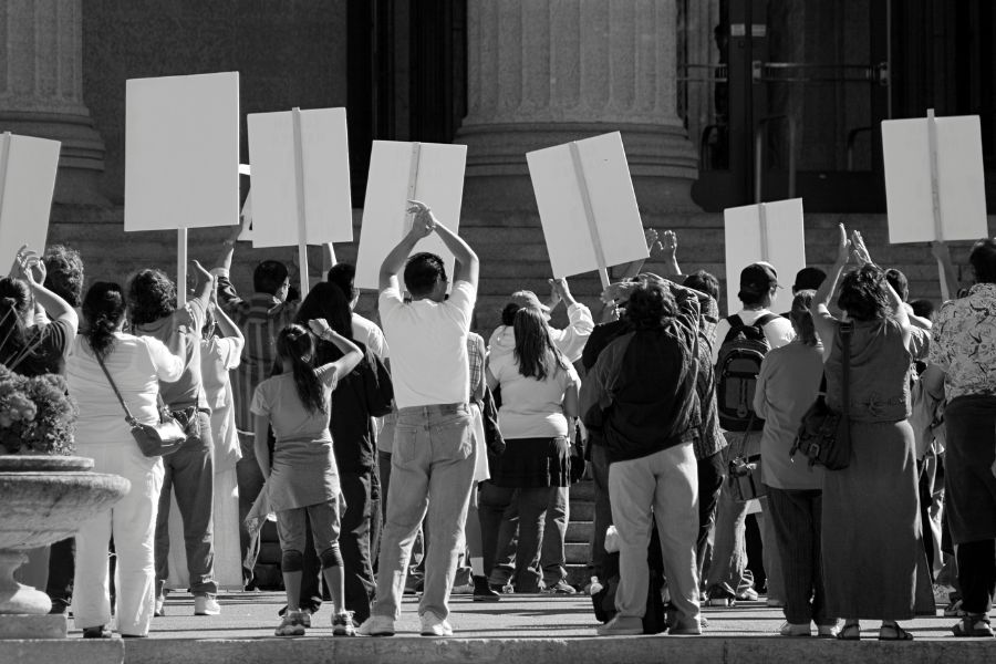 This is an image of a bunch of people protesting in front of a building.