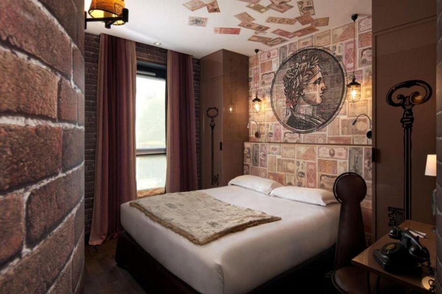 This is an image of a hotel inspired by the seven deadly sins. This particular hotel room has a money theme with artwork of bank notes.