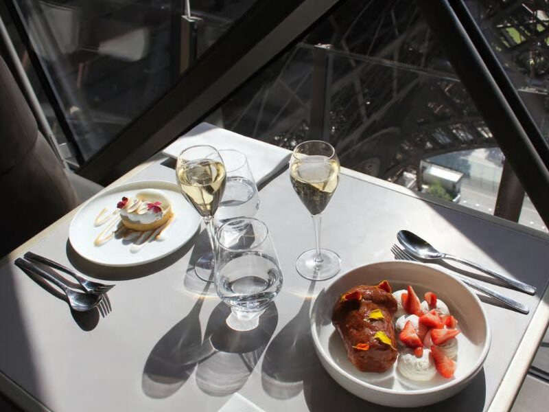 This is an image of a top dining meal on the Eiffel Tower with sun streaming in the weekend.