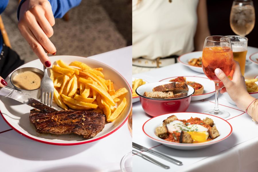 A classic French bistro spread — steak frites with pepper sauce on the left, and eggs with toast and a spritz cocktail on the right, served on white plates with red rims.