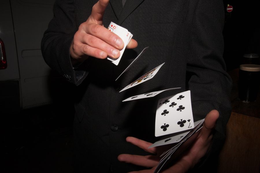 This is an image if a man shuffling a deck of cards seamlessly.