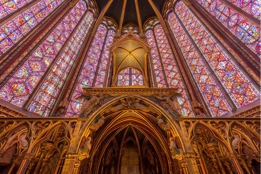 This is an image of the inside of Sainte-Chappelle. It has a beautiful stained-glass window display leading all the way up to the roof.