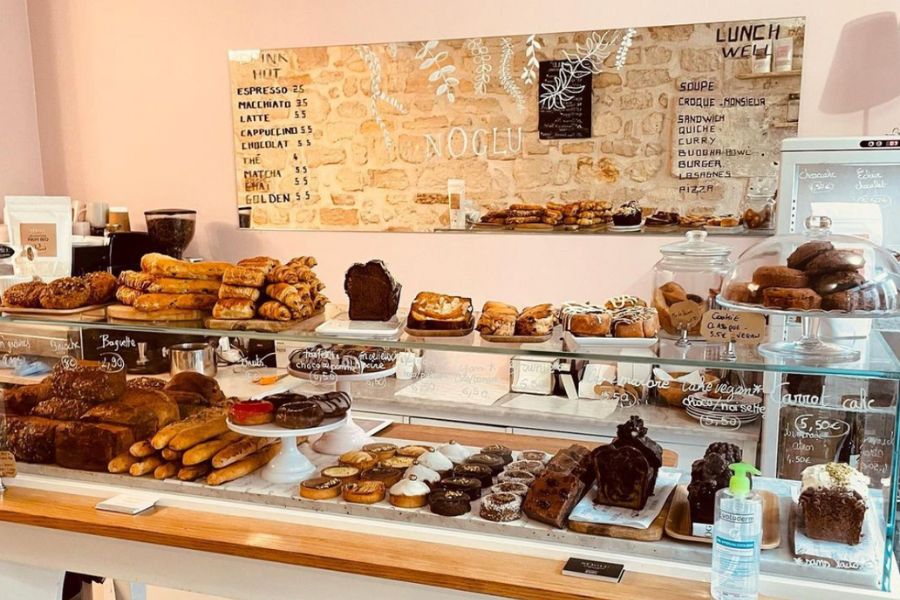 This is an image of a cafe with a full pastry case of GF treats stacked neatly.