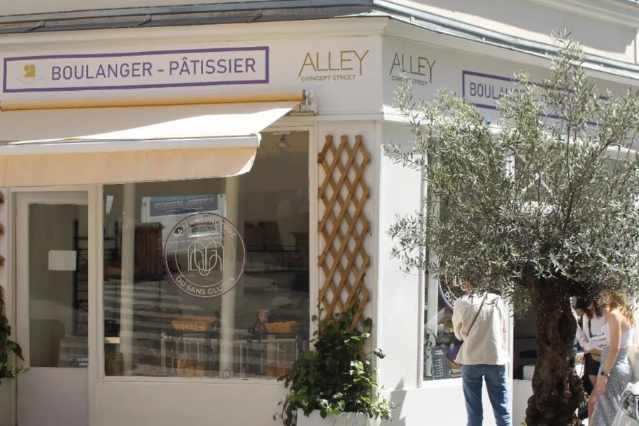 This is an image of the exterior of a cafe which is cream and has a draw out blind at the front forming a small veranda.