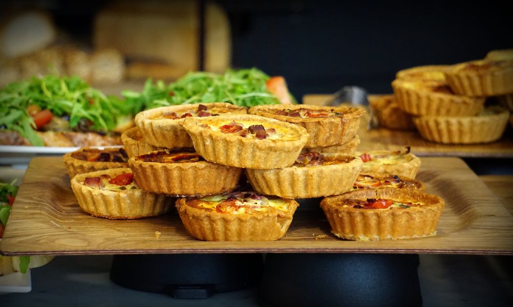 This is an image of a bunch of quiches piled on top of one another.
