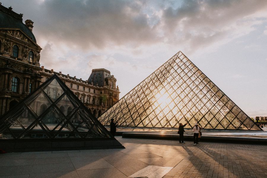 This is an image of the Louvre pyramids with the sun beaming through.