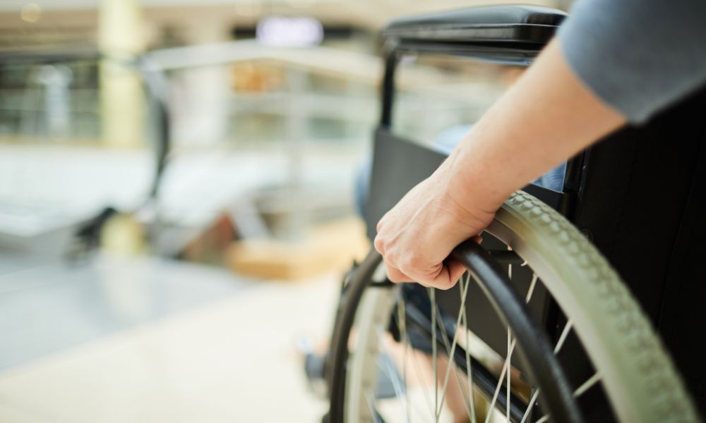 This is an image of a person in a wheelchair going up a ramp.