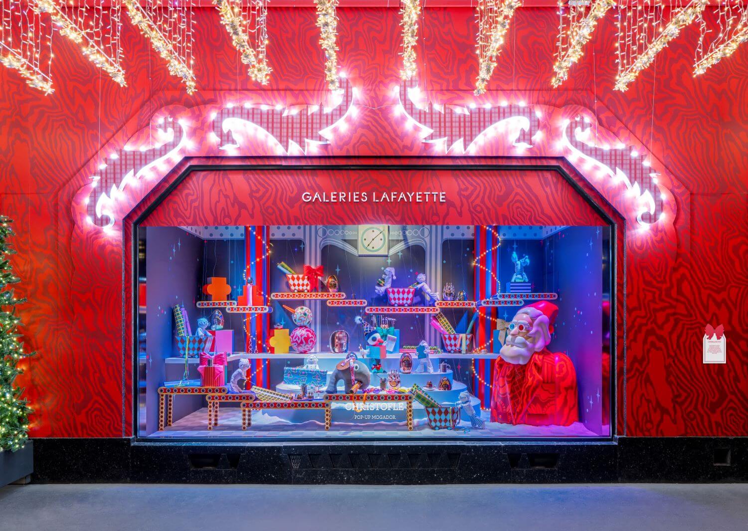 This picture shows a red window from Galeries Lafayette, with Christmas decor.