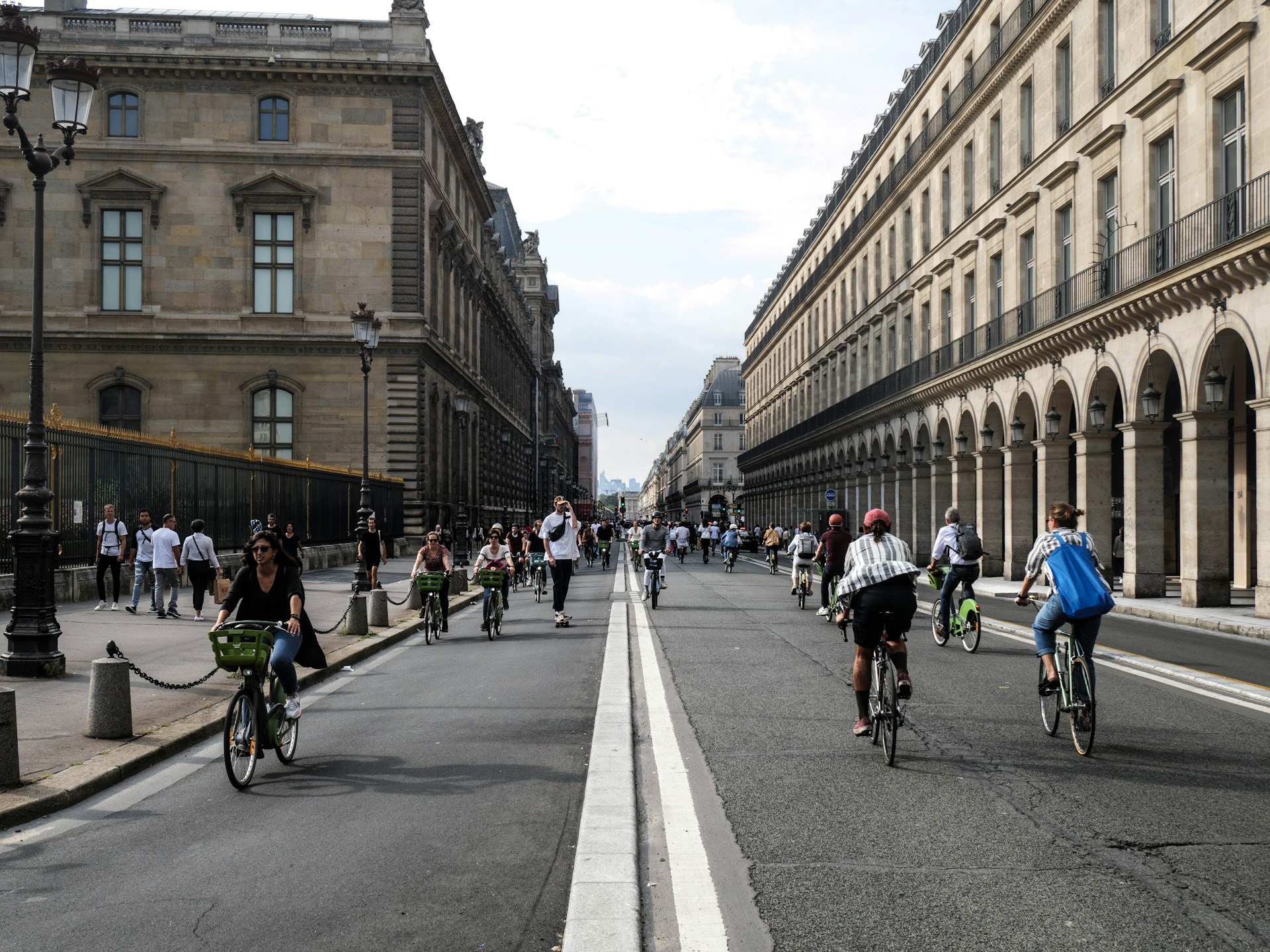 A busy street flanked with traditional Parisian buildings.