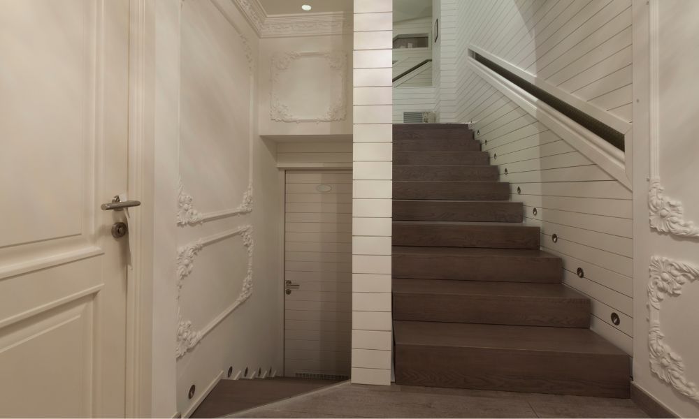 This is an image of a staircase in a hotel. There is no elevator up.
