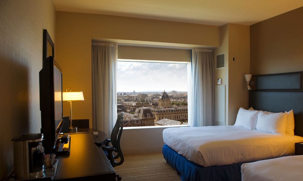 This is an image of a hotel with a nice view of Paris's buildings in the distance.