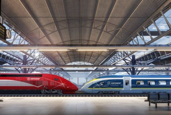 This is an image of two trains sitting on a railway next to eachother.