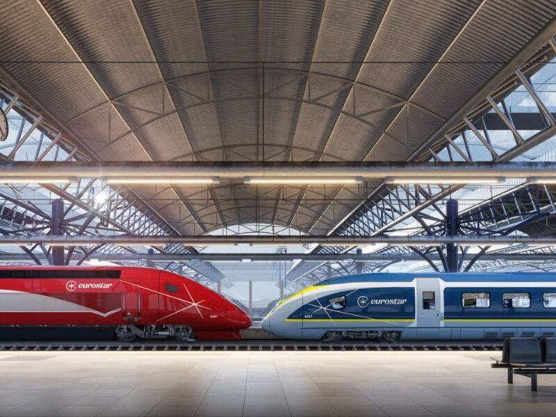 This is an image of two trains sitting on a railway next to eachother.