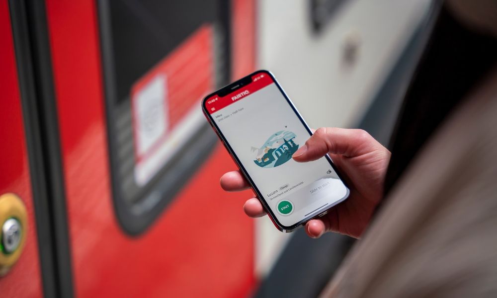 This is an image of a person trying to use their phone to search train tickets.