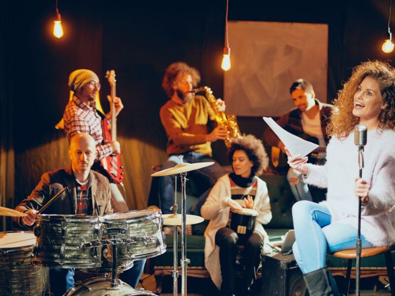 This is an image of a jazz band on stage singing and playing instruments.