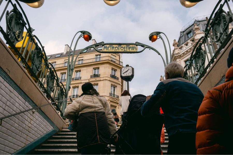 This is an image of the steps up from the Paris metro with the artistic 'metropolitan' sign.