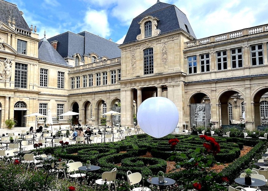 Picture showing Marais District, featuring a rose garden.