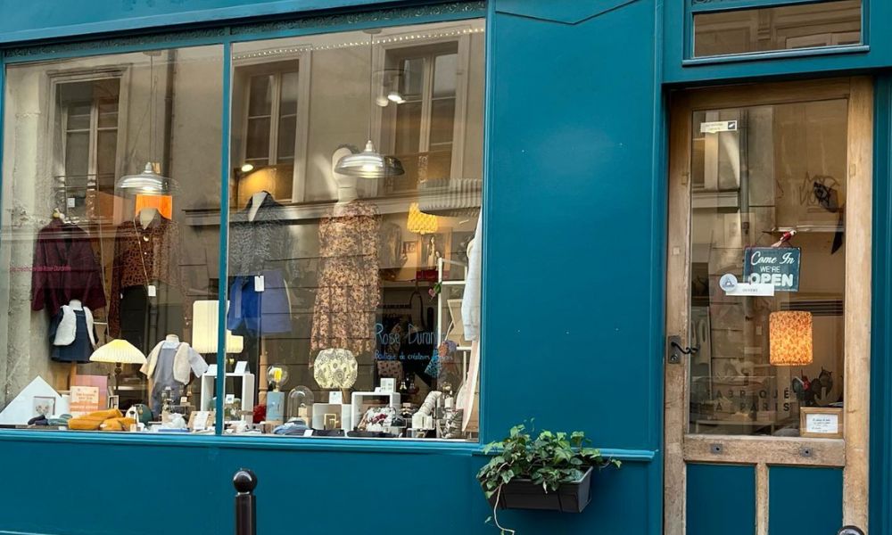 This is an image of a shop front with lots of clothes and jewellery in the window.