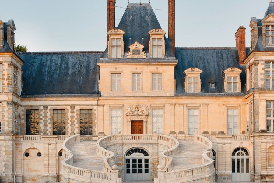 This is an image of a lovely castle with a big spiral staircase at the front.