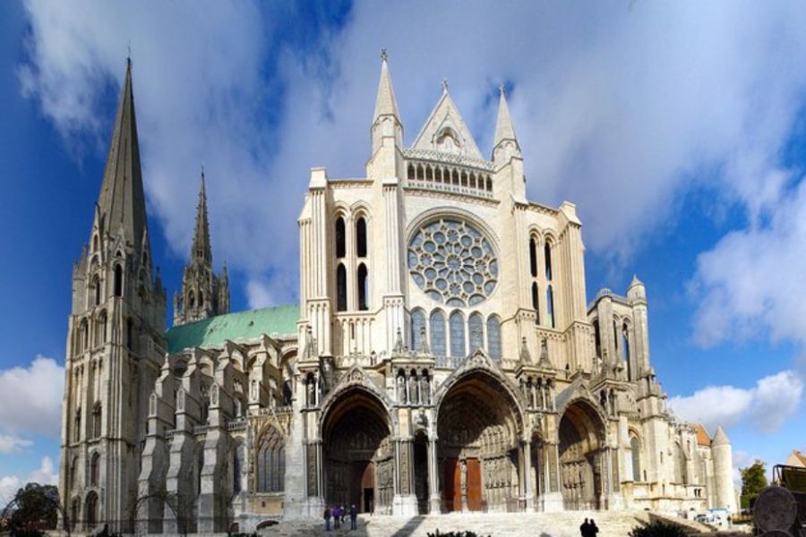 This is an image of a massive cathedral with two sections to it and lots of stained-glass windows.