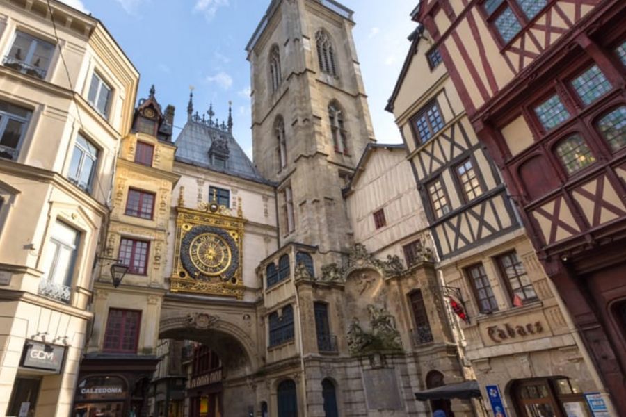 This is an image of an old town with lots of beautiful wooden buildings and fixtures that are reminiscent of an quaint village.
