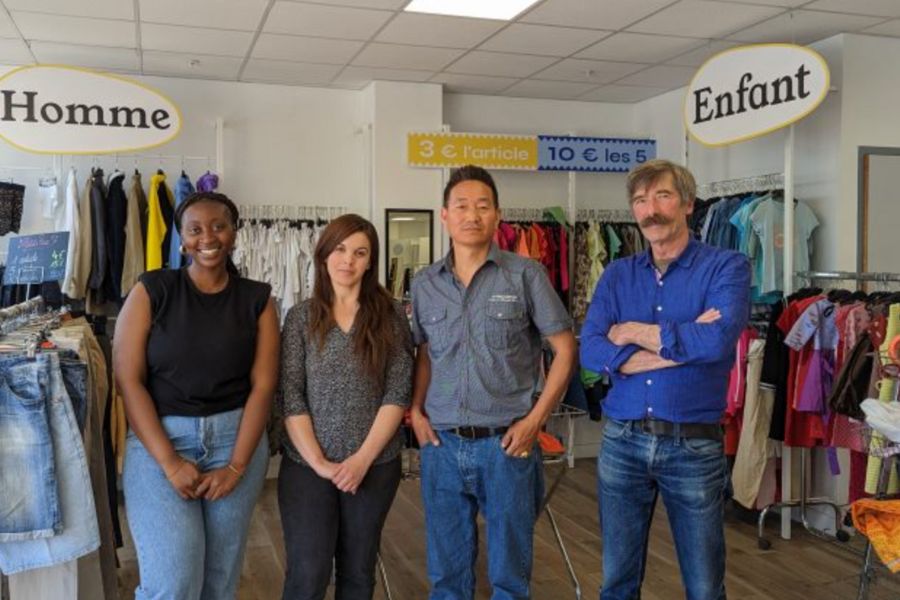 This is an image of four volunteers standing in the middle of a charity shop.