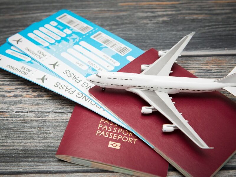 This is an image of a boarding pass inside a pair of passports with a train toy on it.
