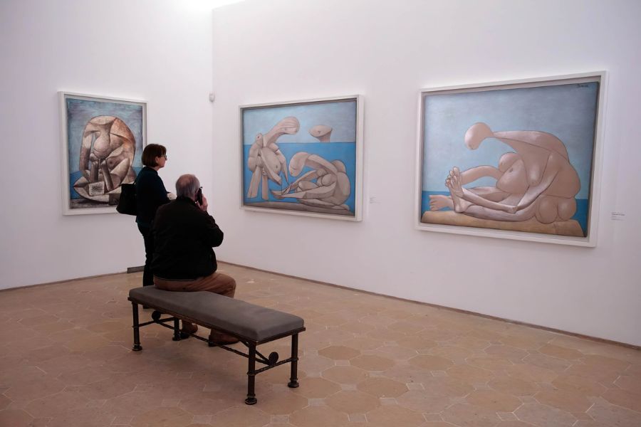 What to do in Paris During the Olympics: This is an image of two people looking intently at Picasso's abstract work in the Paris Picasso Museum.