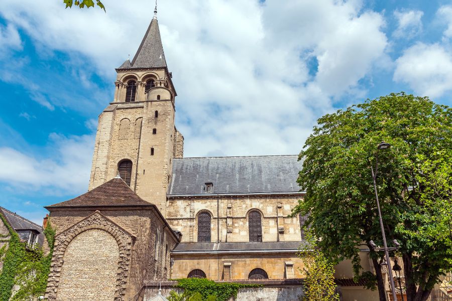 This is an image of a church building with greenery and blue skies.