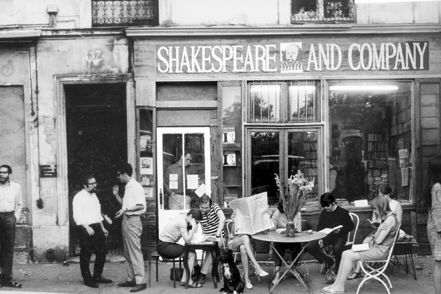 Best literary spots in Paris: This is an image of the front of Shakespeare and Company - a small bookstore in Paris - in the olden days, as it is in black and white.