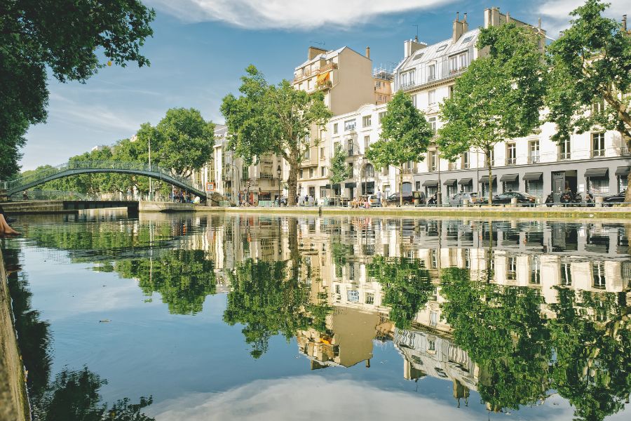 This is Saint-Canal Martin on a nice sunny day, where you can see the reflection of the surrounding buildings in the water.