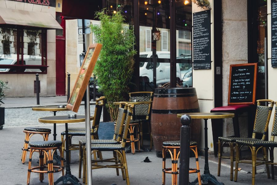 Emily in Paris filming locations: This is an image of the tables and chairs lining a Parisian café that Emily frequents.