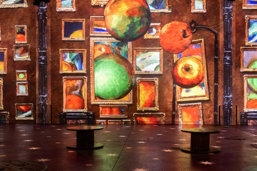 Emily in Paris filming locations: This is an image of a beautiful interactive light exhibition with seats around the gallery for spectators to enjoy.