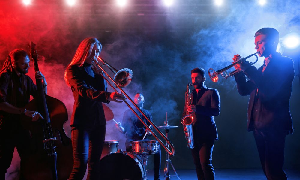 This is an image of a live jazz band playing on the stage in front of a small crowd.