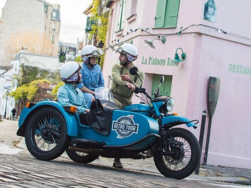 This is an image of a Vintage Sidecar Tour in front of the famous La Maison Rose pink restaurant in Montmartre.
