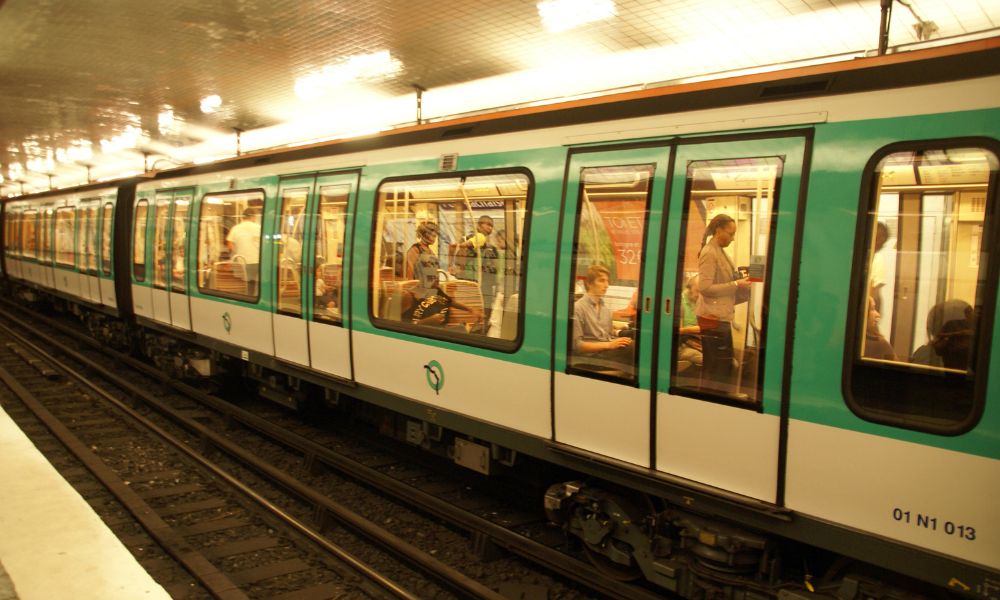This is an image of a Paris metro train parked up on a railway track.