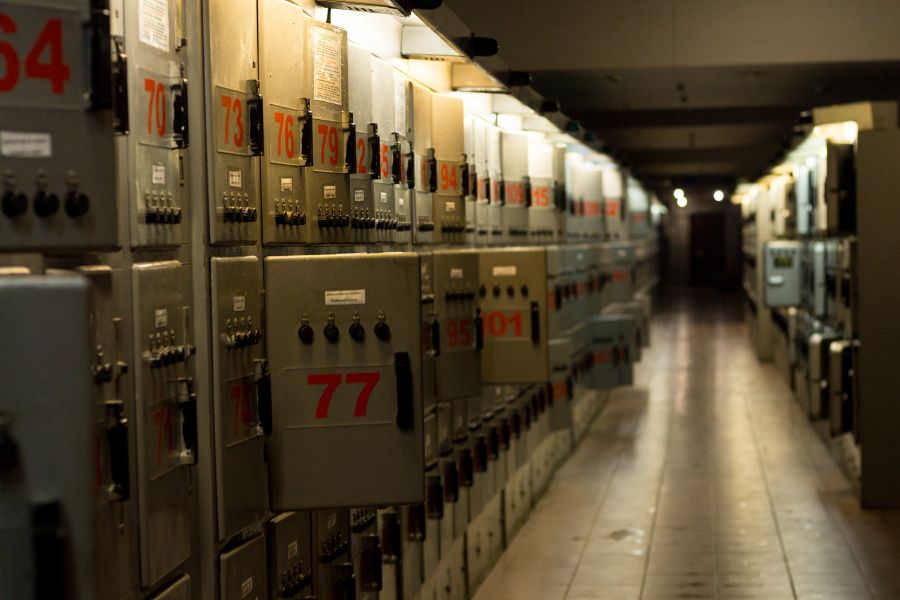 This is an image of a dark room with lots of luggage and storage.