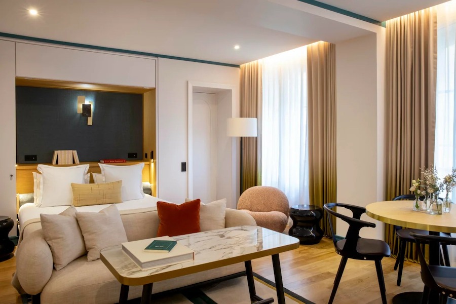 This is an image of a spacious hotel suite with luxurious furnishings throughout.